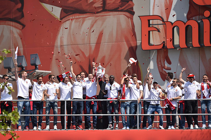 Arsenal players celebrate with the FA Cu